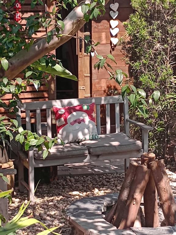 a bench with a stuffed animal sitting on it in a garden at Solar Lisboa 100 m da Praia com vista para mar in Balneário Camboriú