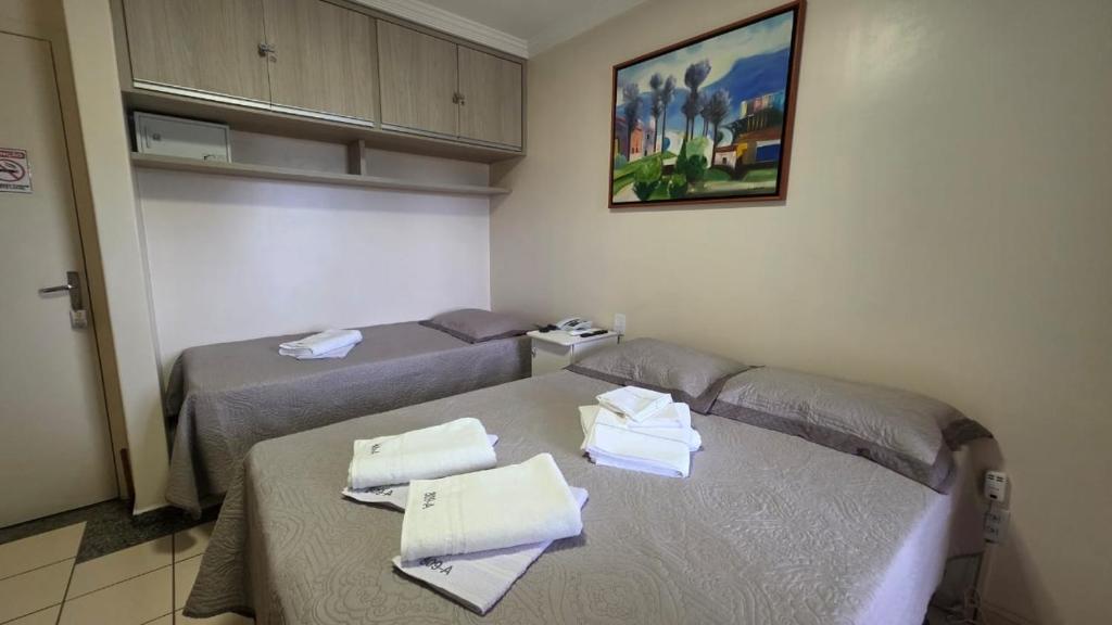 a room with two beds with towels on them at Flat 8A confortável e completo próximo ao Hot Park e Pousada do Rio Quente in Rio Quente