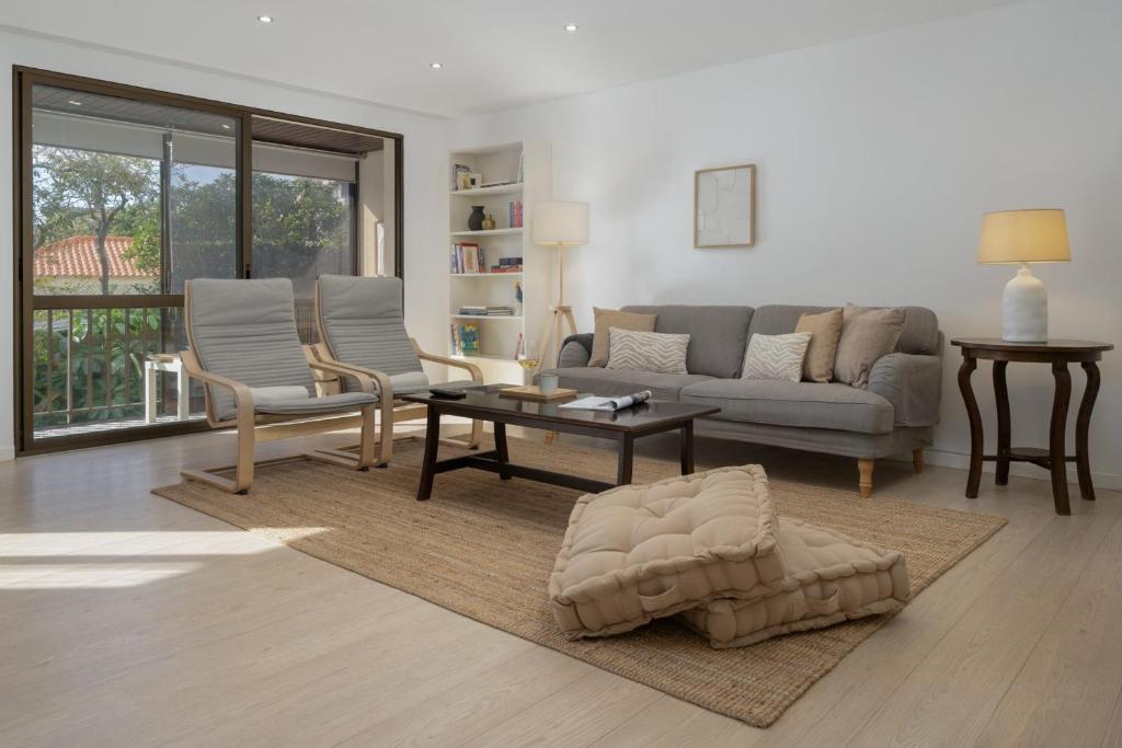 a living room with a couch and a table at Baía II by An Island Apart in Funchal