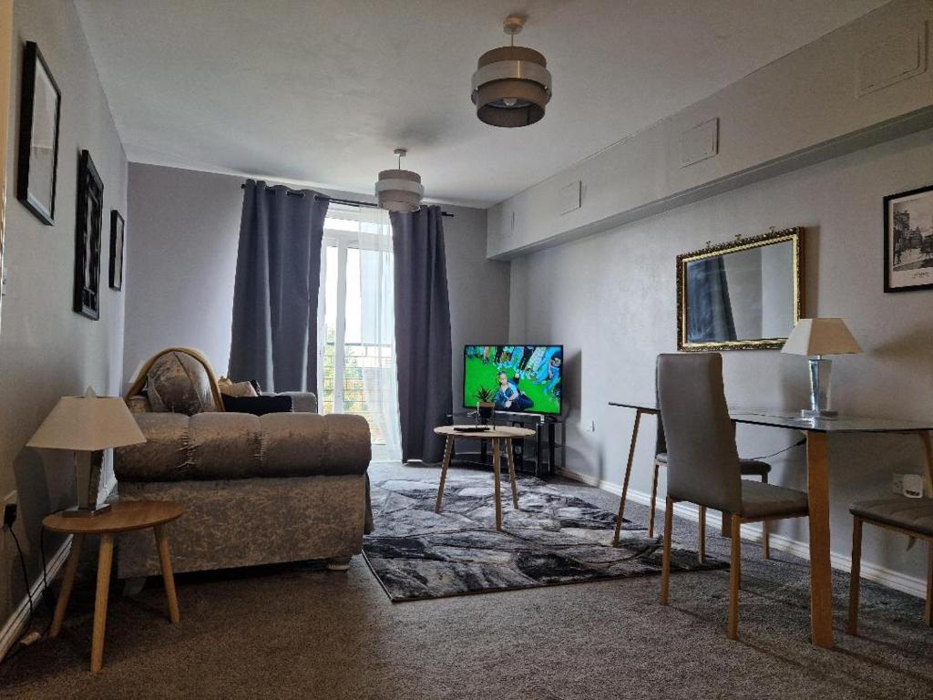 a living room with a couch and a tv at Home Sweet Home, Calverley Court Apartment Home in West Midlands, England in Parkside