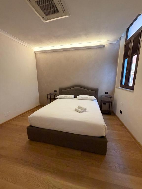 a bedroom with a white bed in a room at Le Stanze Del Duca in Ferrara
