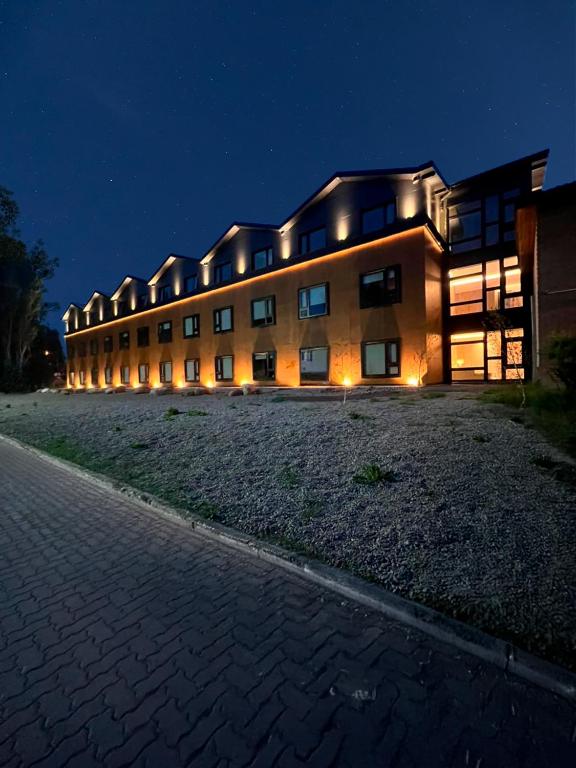 a large building at night with lights on it at Hotel Bahia Redonda in El Calafate
