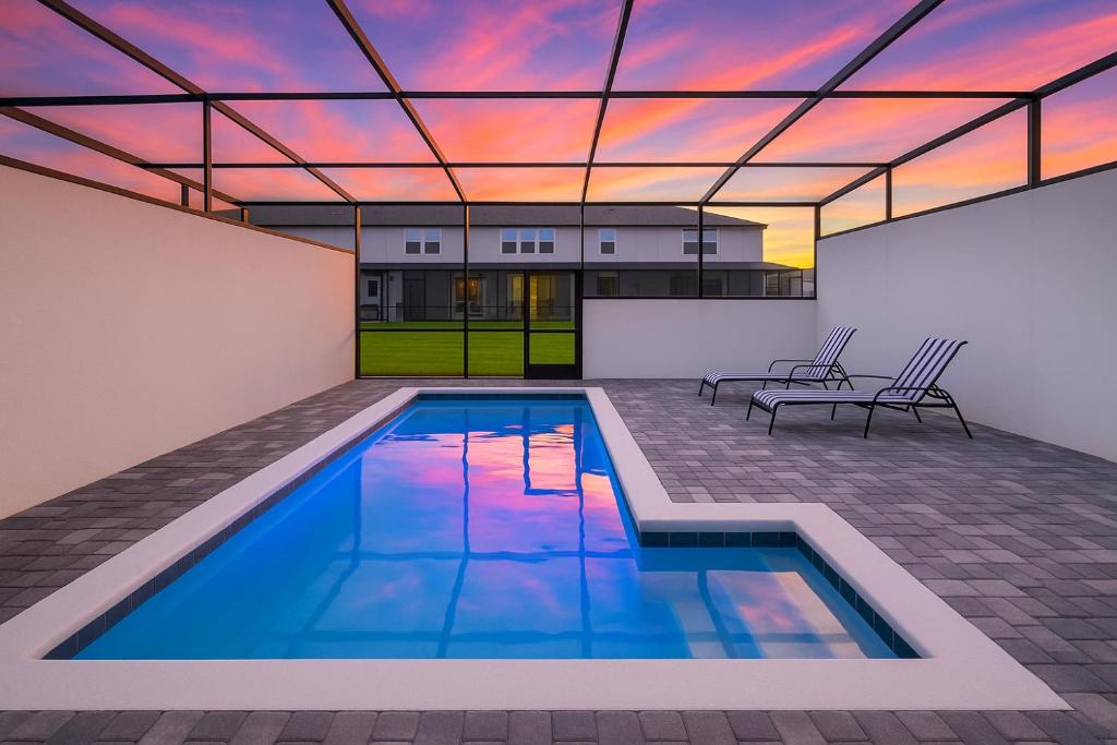 a swimming pool in the middle of a house at Modern and Spacious 5BR Villa Near Disney with Private Pool and Themed Bedrooms in Orlando