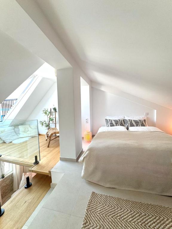 a bedroom with a large bed and a desk at tiny BEACH HOUSES - 2 min to Beach in Salema