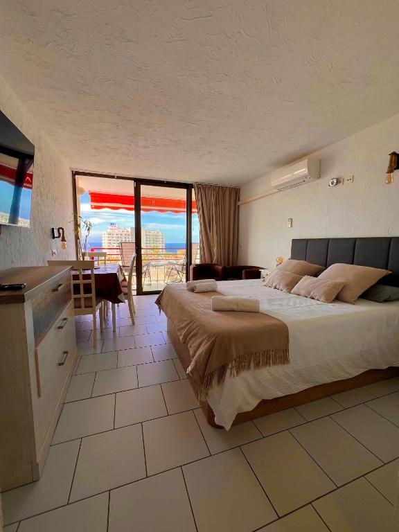 a bedroom with a bed and a view of the ocean at Olimpia Sunset Studio in Costa de Adeje
