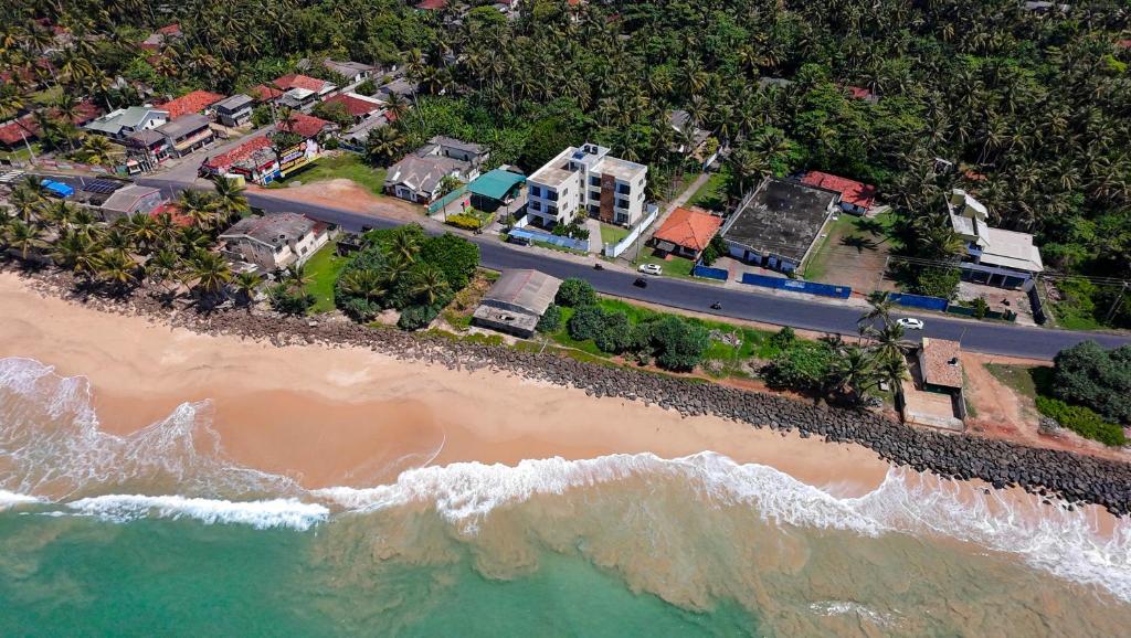 an aerial view of a beach with houses and a road at Lavinia Beach Hotel Ambalangoda in Ambalangoda