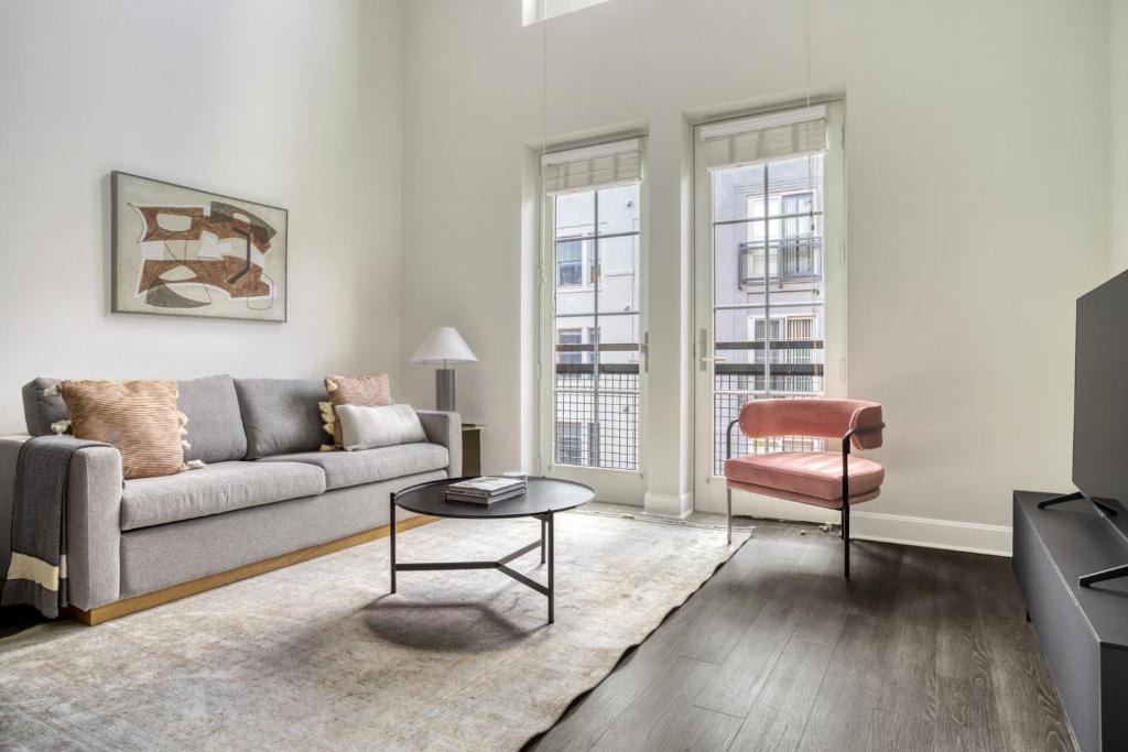 a living room with a couch and a table at Blueground Bethesda fitness center nr Cabin John Park WDC-571 in Bethesda