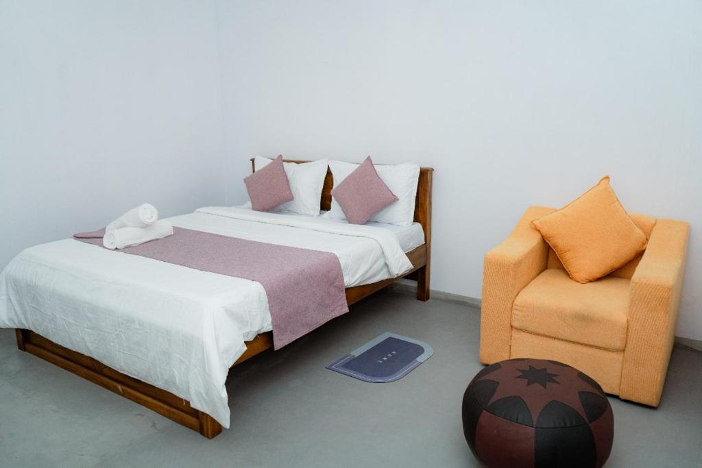 a bedroom with a bed and a chair and a ball at Rest Ahangama in Ahangama