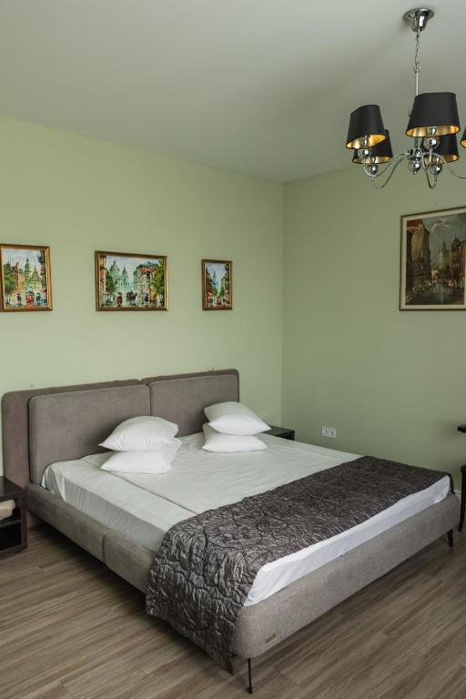 a bedroom with a large bed with two pillows at Churchill-Inn in Vinnytsya