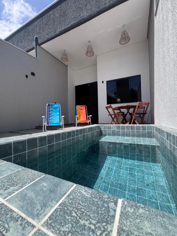 a swimming pool with blue tiles on a house at Casa Ventomar Prea in Cruz