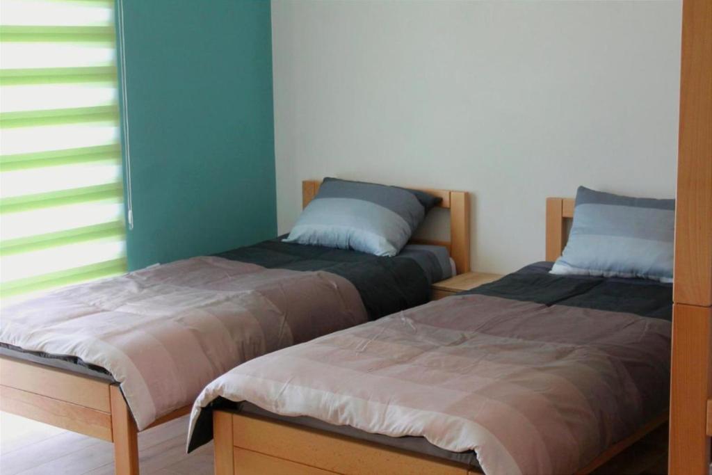 Ένα ή περισσότερα κρεβάτια σε δωμάτιο στο Hostel Sobe Popović