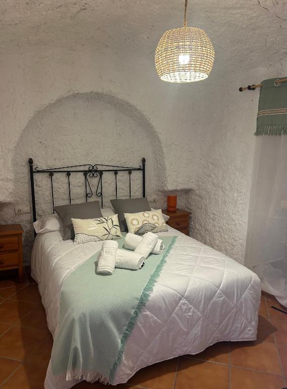 a bedroom with a bed with towels on it at Bike Cueva - Badlands in Gorafe