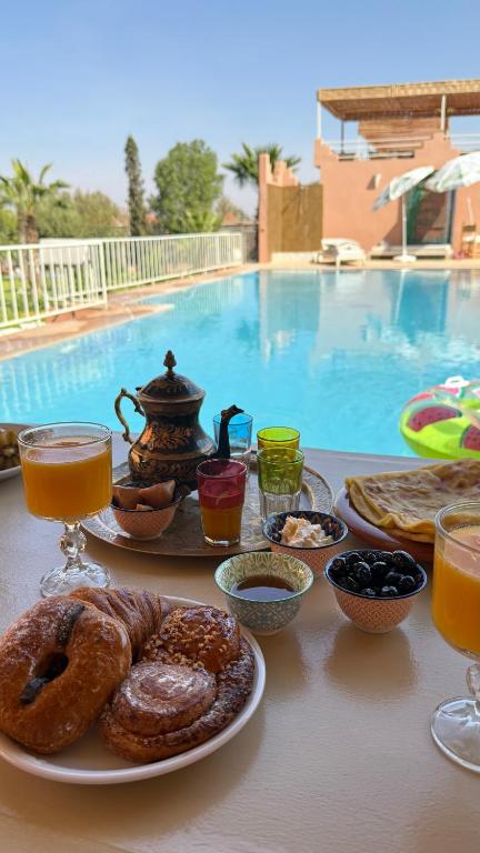a table topped with plates of breakfast foods and drinks at Domaine JJ Marrakech in Marrakesh