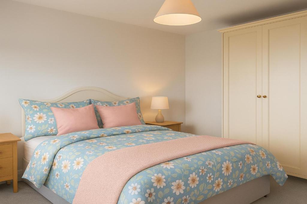 1 dormitorio con 1 cama con sábanas rosas y azules en 2 Bed Apt Russet Court, Cork, en Cork