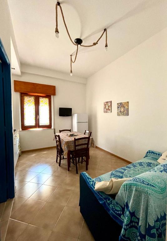 a bedroom with a table and a dining room at A Patedda in Favignana