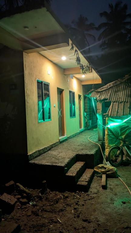 a house with a bike parked outside of it at night at Main beach stay in Gokarna