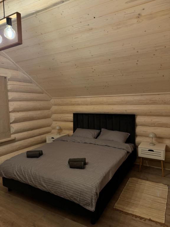Un dormitorio con una cama y paredes de madera. en Black Crest, en Vyshkiv