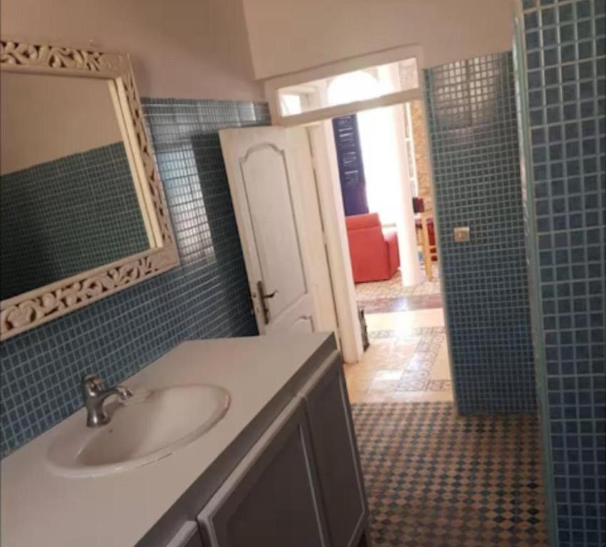 a bathroom with a sink and a mirror and a shower at The Bay House Essaouira in Essaouira