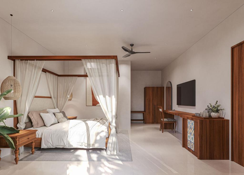 a bedroom with a canopy bed and a television at Aayovea Hotels & Resorts, Ayodhya in Ayodhya