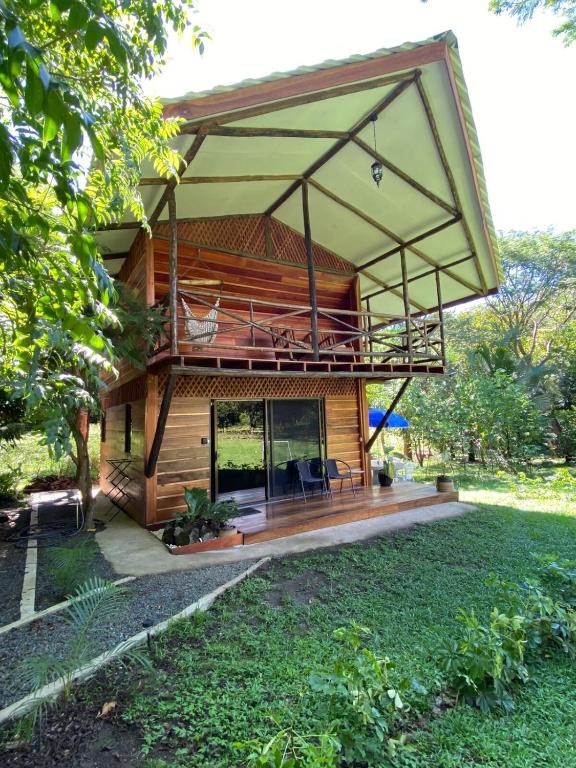 a house with a large deck with a balcony at Casa Oropéndola Refugio natural en Guanacaste in Bagaces