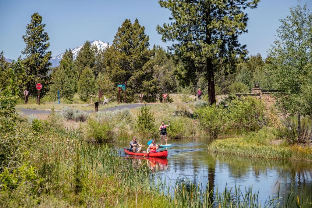 a group of people in a red canoe on a river at Leisure Lane 4 in Sunriver