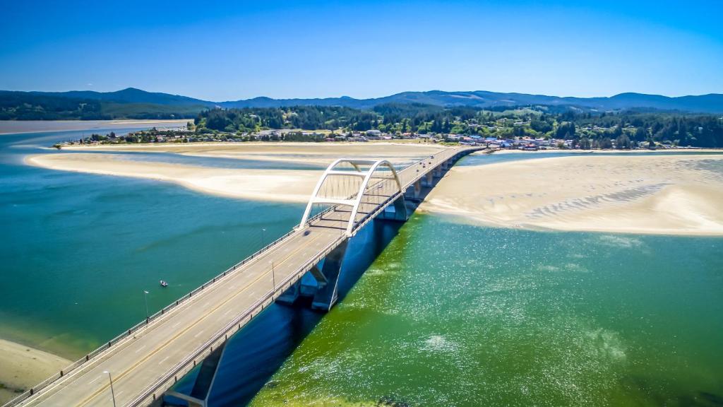 a bridge over the water next to a beach at Waldport Serenity in Waldport