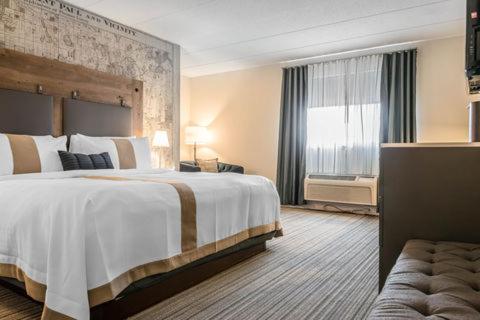 a hotel room with a large bed and a window at enVision Hotel Worcester Downtown in Worcester