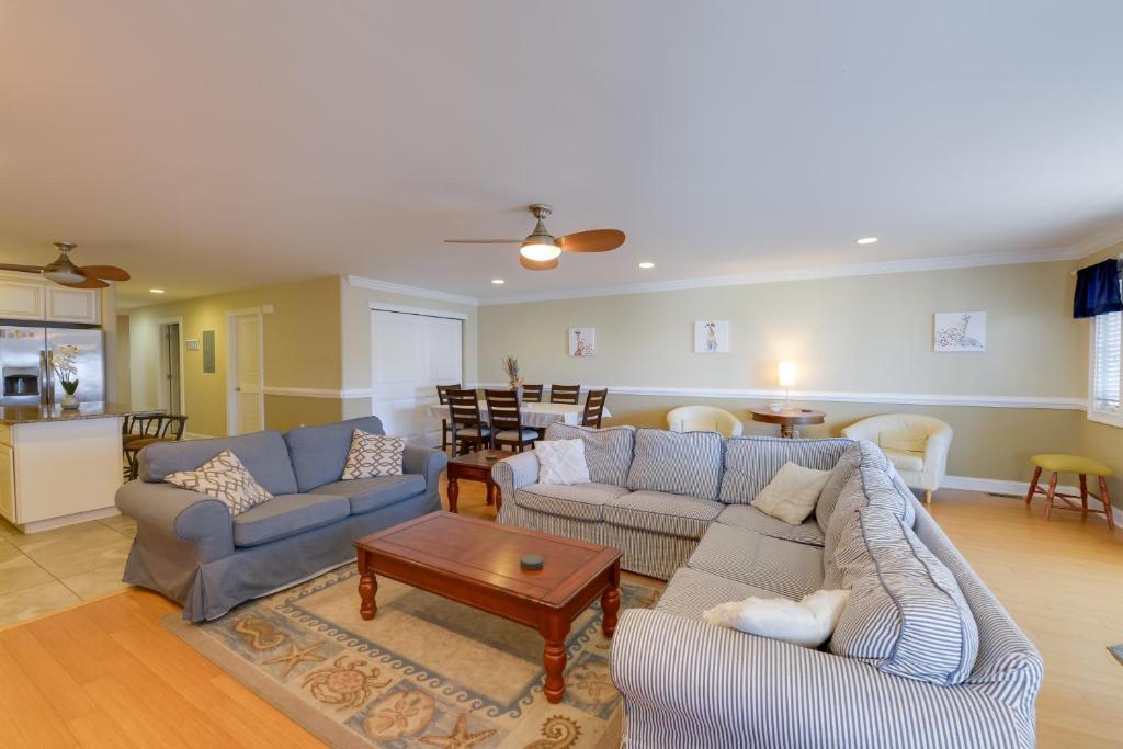 a living room with two couches and a table at Spacious Wildwood Townhome with Covered Balcony in Wildwood