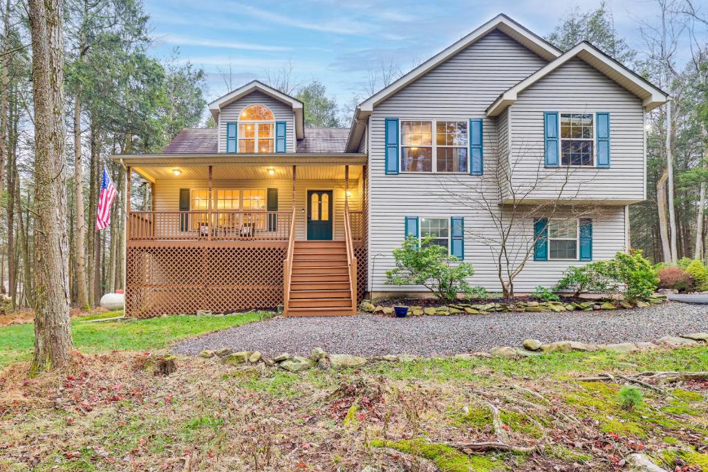 a large white house with a porch at Fire Pit, Games and Outdoor Fun! Poconos Retreat in Blakeslee