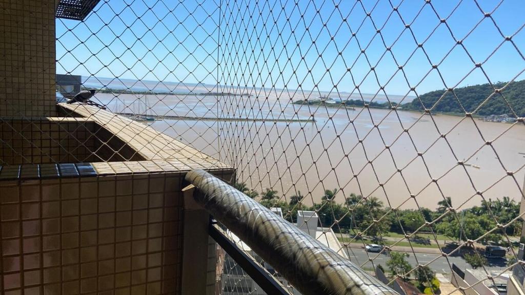 a view of the water from a balcony at Apartment in bairro Fazenda, Itajaí, 2 bedrooms with ocean view in Itajaí