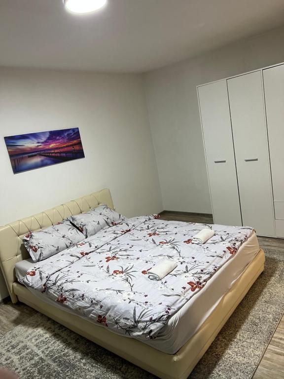 a bedroom with a bed in a white room at Adi apartment in Sarajevo