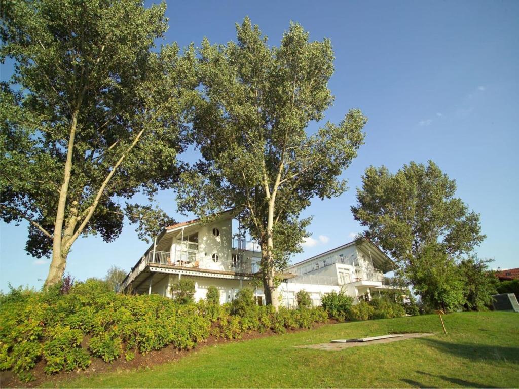 a large white house with trees in front of it at Elegant eingerichtete Ferienwohnung in Granzow