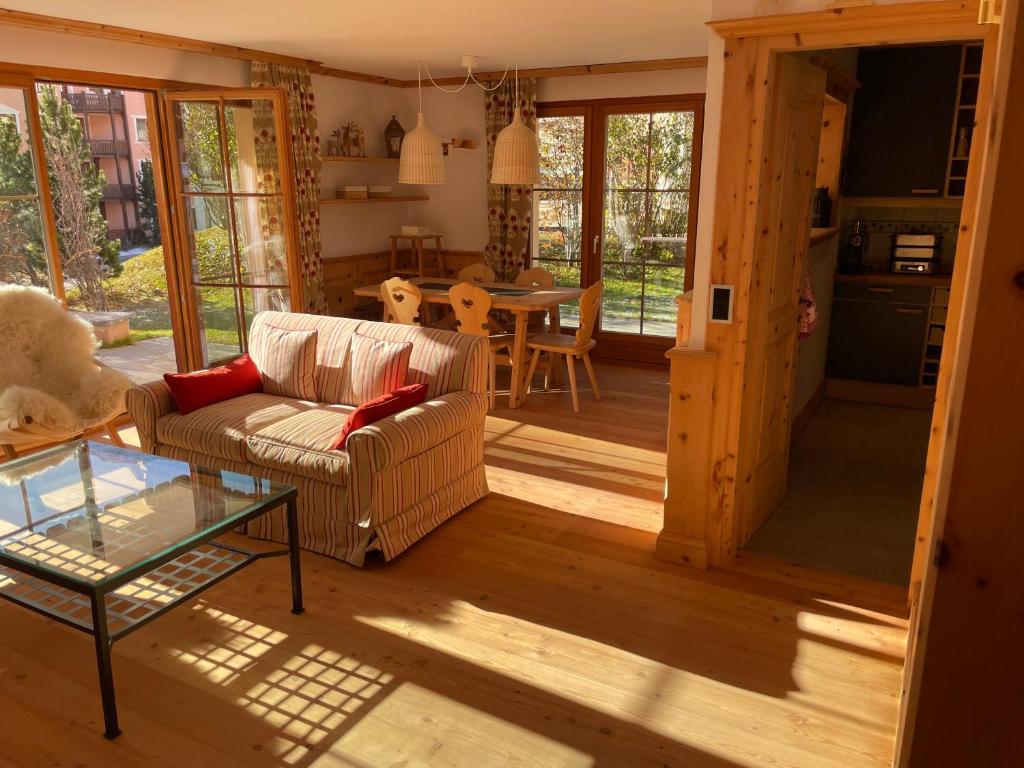 a living room with a couch and a table at 2,5 Zimmer Wohnung mit Bergblick in Engadin in Zuoz