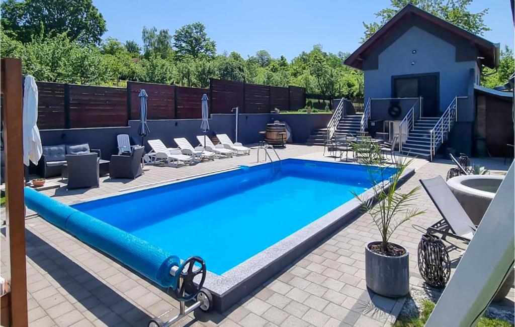 a large swimming pool with chairs at Gorgeous Home In Slavonski Brod With Sauna in Podvinje