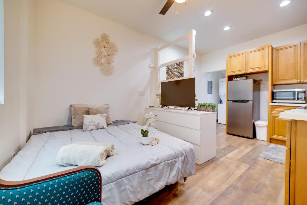 a bedroom with a large bed and a kitchen at Work and Play! Studio Retreat 2 Mi to Dtwn Riverside in Riverside