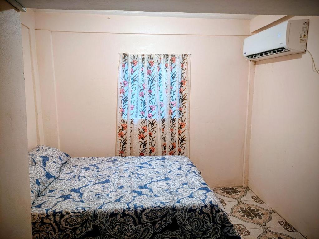 a small bedroom with a bed and a window at BtC Apartments St Paul's in Saint Paulʼs