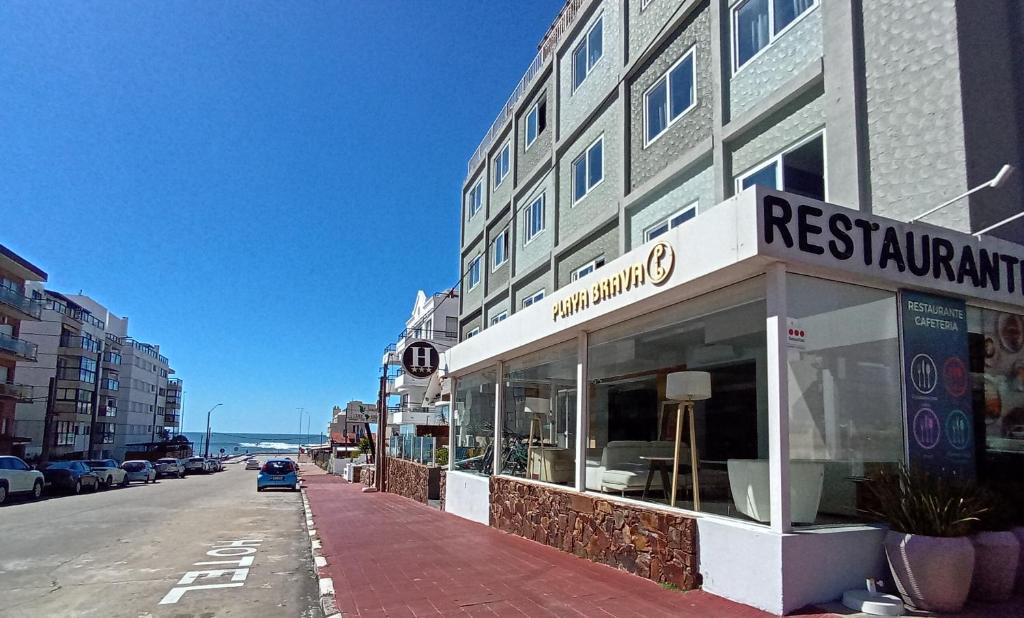 a building on the side of a street with a restaurant at Hotel Playa Brava in Punta del Este