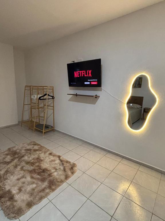 a tv on a wall with a sign that readsnetflix at NEW! Loft in Cancun Center 5 mins from the ADO in Cancún
