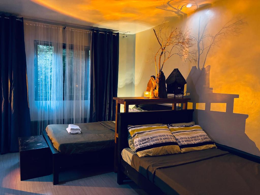 a bedroom with a bed and a window at WN Hilltop B&B by Smart Stay 2600 in Baguio