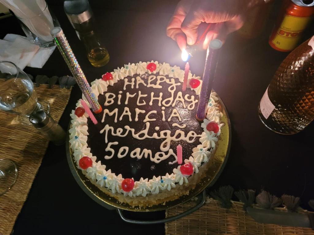 a birthday cake with a candle on a table at Merzouga delicioso Camp in Oulad Akkou