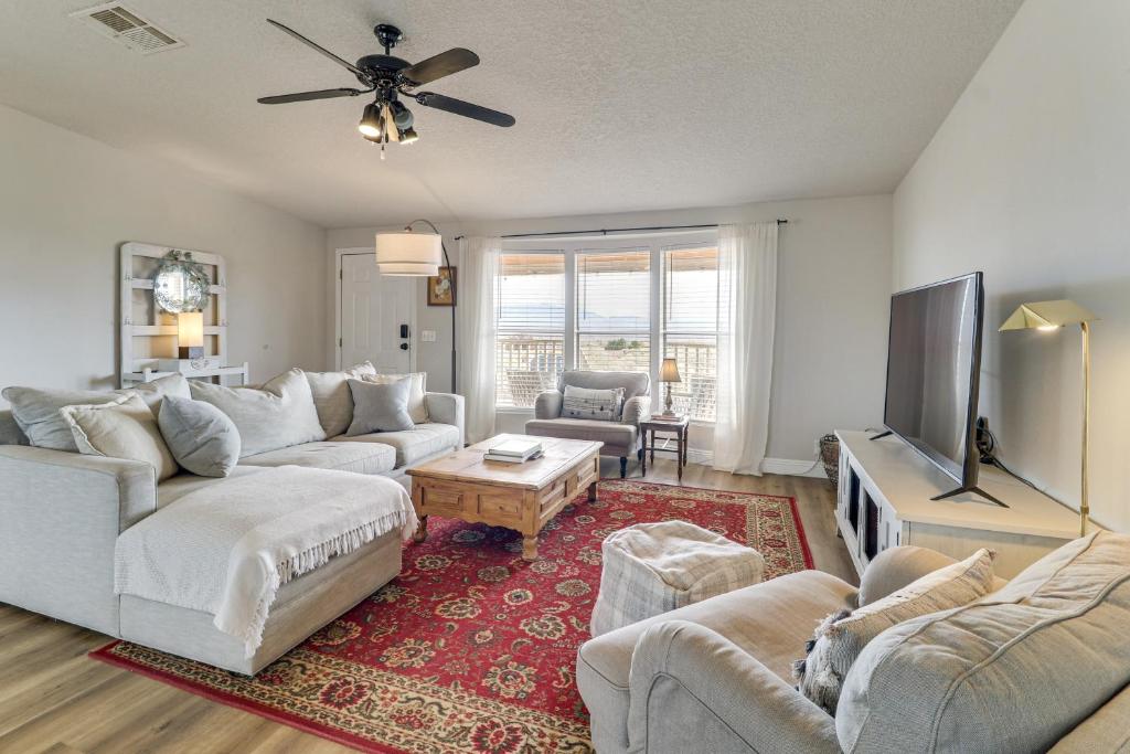 a living room with couches and a flat screen tv at Scenic Sandia Mtn Views! Cozy Rio Rancho Retreat in Paradise Hills