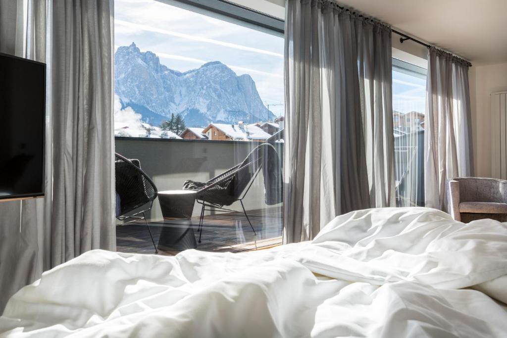 Un pat sau paturi într-o cameră la Hotel MAYR