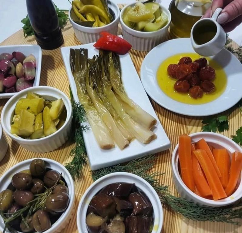 a table topped with plates of vegetables and other dishes at Guesthouse Lord Byron in Tepelenë