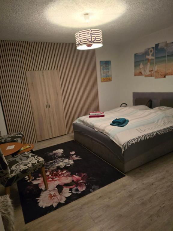 a bedroom with a bed and a rug at Heimathafen Ückeritz Boutique Hotel in Ueckeritz