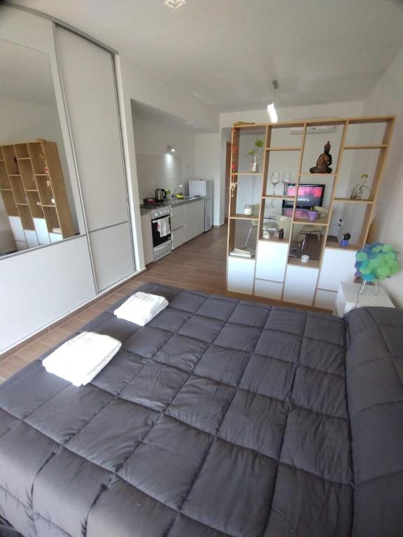 a large bedroom with a large bed in a room at Monoambiente a estrenar con Balcón in La Plata