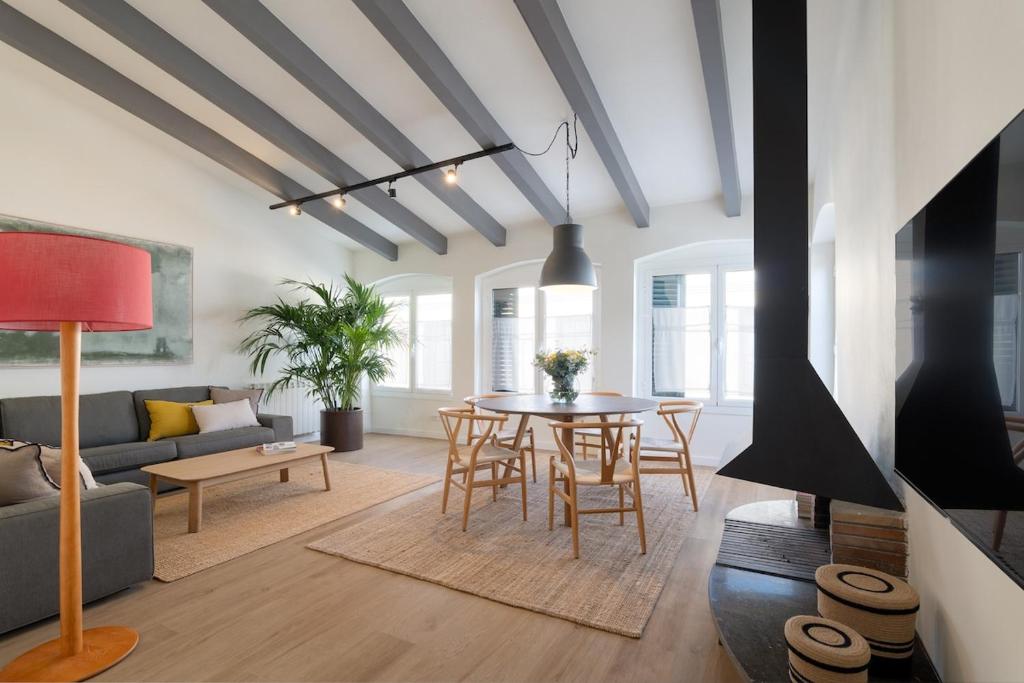 een woonkamer met een tafel en een bank bij Apartamento Rosari II in Vilassar de Mar