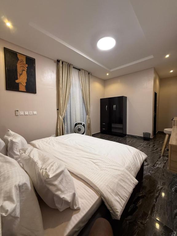 a bedroom with two large beds and a window at The Dream Residence in Abuja