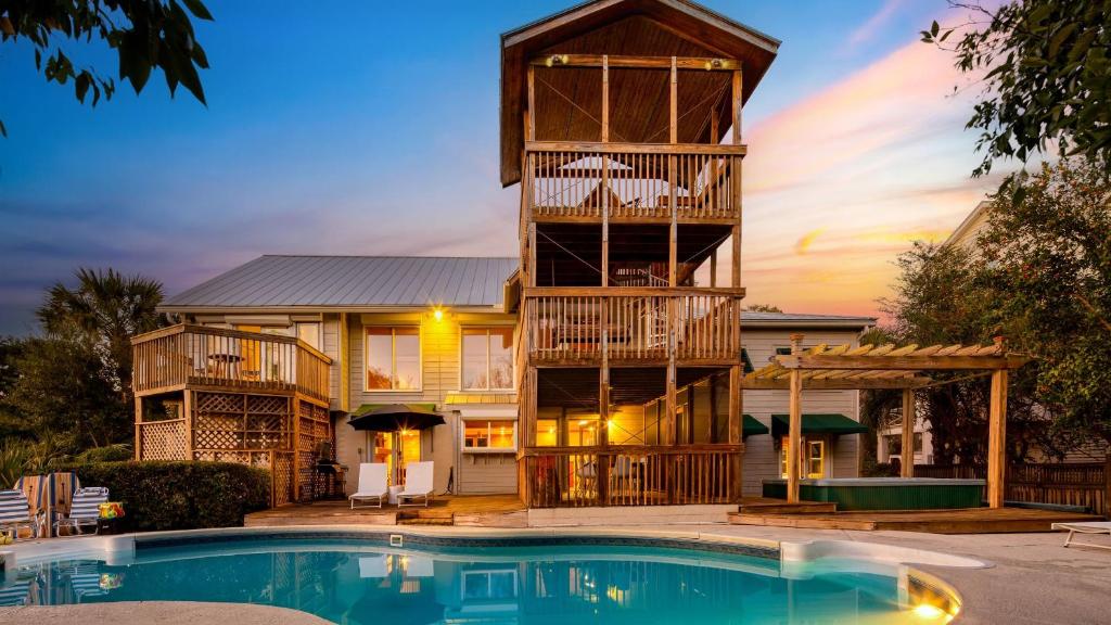 a house with a balcony and a swimming pool at Raven by AvantStay Entertainers Dream w Pool Hot Tub Game Room 9 BRs in Sullivans Island