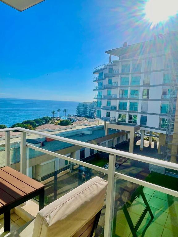 a balcony with a view of a building and the ocean at Rodamar Apartment Forum Funchal in Funchal