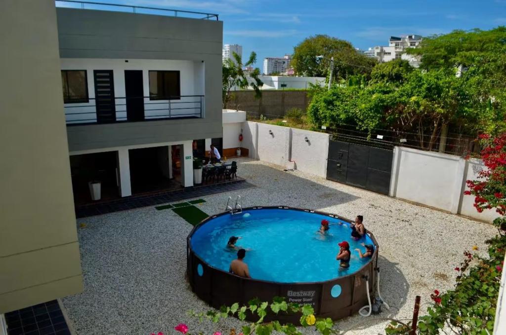 a group of people in a swimming pool on top of a building at Villa vacacional piscina en playa dormida in Santa Marta
